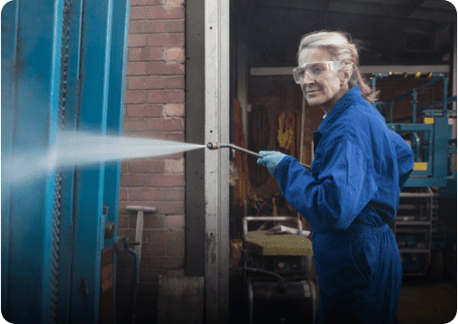 a woman cleaning a surface with water spray