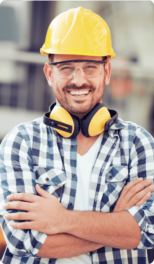A contractor with Yellow helmet smiling for a portrait