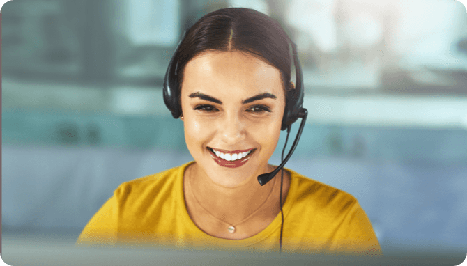 A smiling man on a phone call in a cafeteria