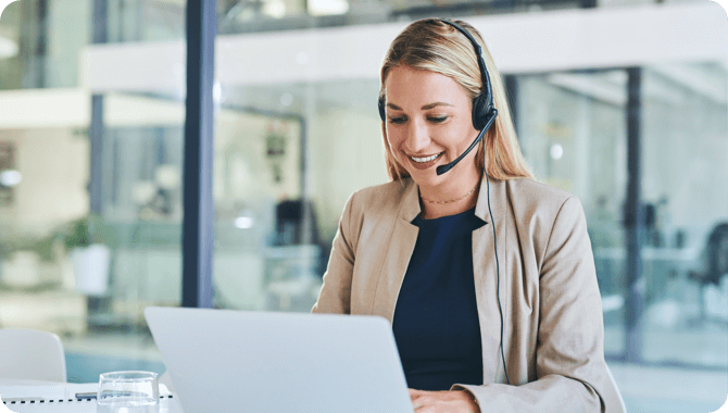 A smiling man on a phone call in a cafeteria
