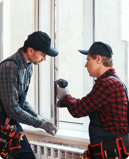 two men working to repair a window