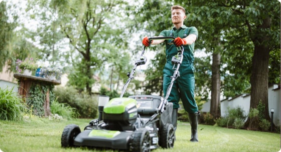 Guy pushing lawn mower