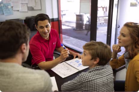 mathnasium tutor having a meeting with a kid and his parents